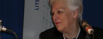 alte Dame vor Banner des Literaturhauses