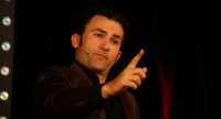Fatih Cevikkollu gestikulierend auf der Bühne, Quelle: DTF