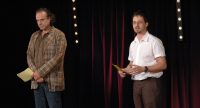 Mann und Kerim Arpad mit Karteikarten vor Vorhang, Quelle: DTF
