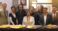 Gruppenbild hinter Buffet vor Wand mit Fotos, Quelle: DTF