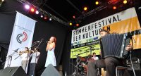 Fatima Spar and the Freedom Fries auf der Bühne vor Banner des Sommerfestes und des DTF, Quelle: DTF