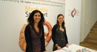 zwei Frauen lächeln in die Kamera, sie stehen hinterm Stand des DTF, Quelle: DTF