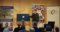 Mann spricht am Podium vor Banner der lpb und des DTF, Quelle: DTF