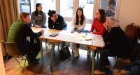 6 Workshopteilnehmende sitzen um einen Tisch und diskutieren, Quelle: DTF