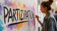 Die junge Künstlerin erstellt ein Graffiti und schreibt das Wort "Partizipation", Quelle: DTF